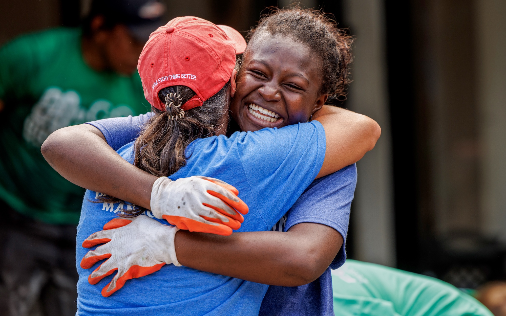 Two community members embrace at a volunteer event to support building a stronger Chicago region.
